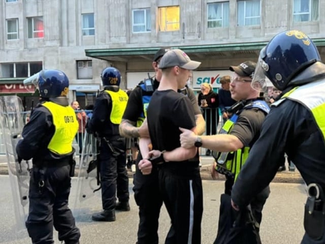 police officers detain some far right protesters after they tried to cross to the side of the opposing group in plymouth united kingdom on august 05 2024 photo anadalo agency